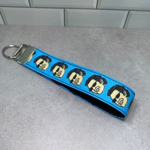 Jeff Goldblum wearing sunglasses wristlet key fob