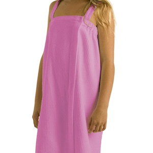 May include: A pink hooded towel wrap with adjustable straps. The towel is made of soft, absorbent material and is perfect for drying off after a shower or bath.