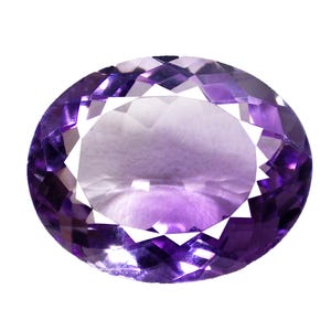 May include: An oval-cut amethyst gemstone with a faceted surface. The gem displays a gradient of purple hues, ranging from a deep violet to a lighter lavender shade in the center. The gemstone is set against a white background.