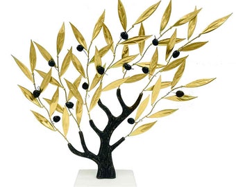 May include: A gold metal olive tree sculpture with black olives and a black wooden trunk. The tree is on a white marble base.