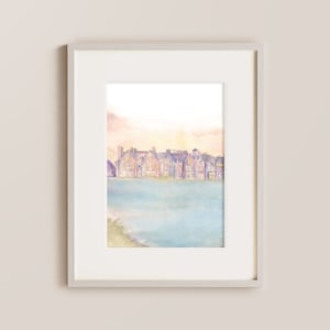 May include: A watercolor painting of a row of houses with a lake in the foreground. The houses are painted in shades of pink, purple, and blue, and the lake is a light blue color. The sky is a soft orange and pink.
