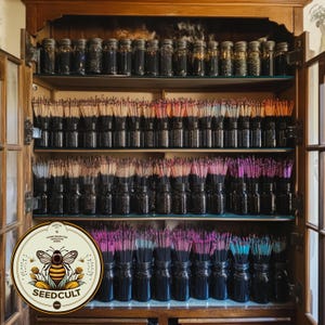 May include: A wooden cabinet with multiple shelves filled with glass jars containing bundles of incense sticks in various colors. The jars are arranged in rows and columns. A logo for "Seedcult" is visible in the lower left corner of the image.