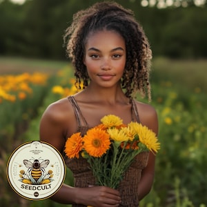 May include: A woman with curly brown hair holds a bouquet of yellow and orange flowers in a field. The flowers are in bloom and the woman is smiling. A logo for Seedcult is in the foreground.