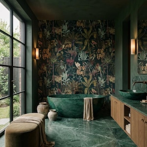 May include: A bathroom featuring a deep green oval soaking tub, a green marble floor, and a vanity with a green marble countertop. The walls are painted dark green, with one wall covered in a dark botanical wallpaper. A beige bench sits nearby.