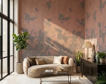 May include: A living room featuring a curved beige sofa with four throw pillows, a rectangular coffee table, and an irregular cream-colored rug. The walls are covered in a dusty rose wallpaper with a repeating dark gray crane bird pattern.