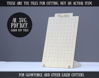 May include: A laser cut earring display stand made of wood with a light brown finish. The stand has a rectangular base and a vertical panel with multiple holes for holding earrings. The text "Halchi Belluni" is printed on the top of the stand. The text "AI. SVG. PDF.DXF. LASER CUT FILES" is printed on a black circle. The text "FOR GLOWFORGE AND OTHER LASER CUTTERS" is printed below the stand.