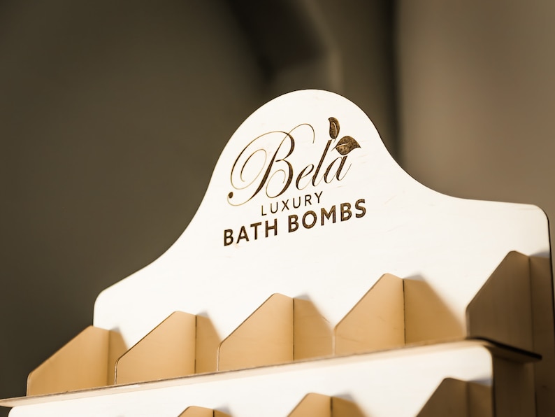 Tiered soap display stand with dividers, perfect for organizing soaps in a bathroom setup