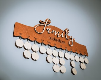 May include: A wooden wall calendar with the word "Family Celebrations" written on it. The calendar has 12 months, each with a circle for marking special events. The circles are blank and ready to be decorated.