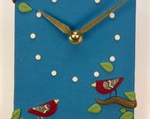 Clock with Red Birds on Blue Background