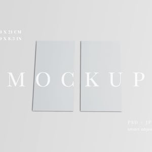 May include: Two rectangular, light gray cards, each measuring 3.9 x 8.3 inches, are displayed on a light gray background. The word "MOCKUP" is written in a serif font across the center. The bottom right corner includes the text "PSD + JPG smart object."