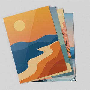 May include: A stack of art prints featuring minimalist landscape designs. The prints showcase a sunset over the ocean, a beach scene, and a tree with pink blossoms. The color palette includes shades of orange, blue, and beige.