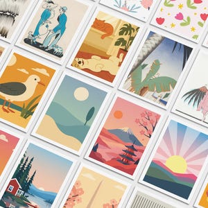 May include: A collection of art prints featuring various illustrations. The prints showcase diverse themes, including landscapes, animals, and figures, with a range of color palettes. Each print is displayed in a white frame, creating a cohesive aesthetic.