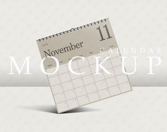 Może przedstawiać: Szablon kalendarza w kolorze beżowym z zaznaczonym miesiącem listopad 2023 i numerem 11. Tekst "CALENDAR MOCKUP" jest nadrukowany na obrazku na biało.