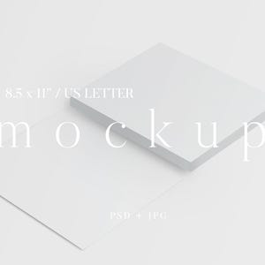 May include: A mockup image featuring two white stacks of paper, one slightly elevated. The text "8.5 x 11" / US LETTER" and "mockup" are displayed in a light font. The image also includes "PSD + JPG".