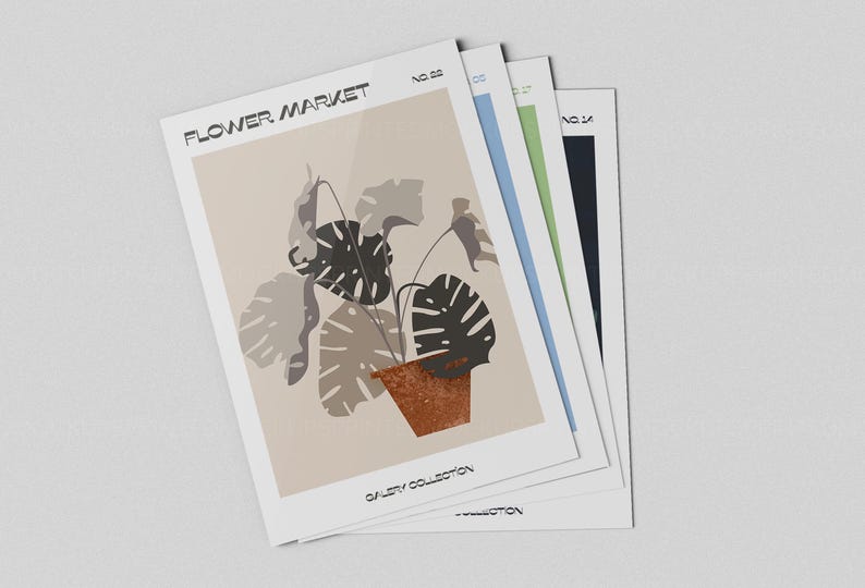 May include: A stack of art prints featuring a botanical illustration of a plant in a terracotta pot. The prints have the text "FLOWER MARKET" and "GALLERY COLLECTION". The prints have a beige, blue, green, and black border.