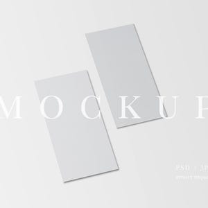 May include: Two rectangular, light gray mockups are angled on a white background. The word "MOCKUP" is displayed in a light gray font across the image. The bottom right corner of the image displays "PSD - JPG" and "smart object".