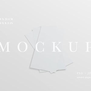 May include: A mockup image featuring a stack of white rectangular papers, with the text "MOCKUP" in a light font. The papers measure 3.9 x 8.3 inches and 9.9 x 21 cm. The image also includes the text "PSD - JPG smart object".