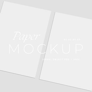 May include: Two white paper mockups on a light gray background. The text "Paper MOCKUP" is displayed in a delicate font. Additional text indicates the paper sizes available: A2, A3, A4, A5. The bottom text reads "SMART OBJECT PSD + JPEG".