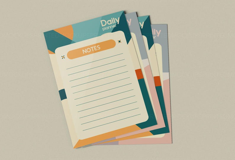 May include: A stack of daily planner notepads with a geometric design. The notepads have a cream-colored background with lined pages and the word "NOTES" in an orange rectangle. The top notepad has the words "Daily planner" in teal.