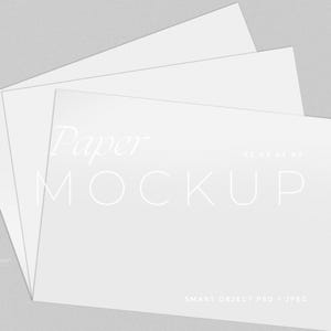May include: A mockup of three white paper sheets, slightly fanned out, against a light gray background. The top sheet displays the words "Paper MOCKUP" in a minimalist font. The bottom of the sheet includes the text "SMART OBJECT PSD + JPEG".