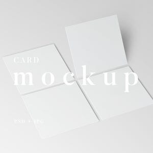 May include: A mockup of four white square cards arranged in a slightly open formation. The word "CARD" is at the top, and "mockup" is below it. The text "PSD + JPG" is at the bottom. The cards are on a white background.