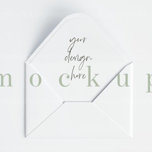 May include: White envelope with a folded flap. The envelope is lying flat on a white surface. The text "your design here" is written in black ink on the inside of the envelope.