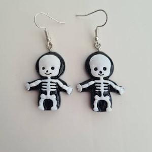 Very cute Halloween skeleton dangle/drop earrings. Perfect for all Halloween lovers. Handmade little skeleton. Scary.