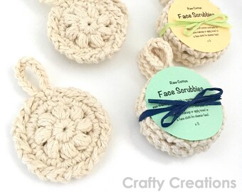 May include: Three crocheted face scrubbies with a loop handle. The scrubbies are made of natural cotton and are packaged with a green and white label that reads "Raw Cotton Face Scrubbies" and "eco-friendly. No machine wash. Use with soap or apply toner or a face cloth to cleanse face. x3"