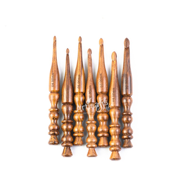 May include: Set of eight wooden crochet hooks in various sizes, ranging from 4.00mm to 10.00mm. The hooks are brown and have a smooth, polished finish.