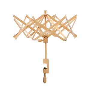 May include: A wooden yarn swift with a clamp base. The swift has a starburst design and is made of natural wood.