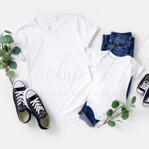 May include: White t-shirt and bodysuit mockup with blue jeans, black sneakers, and eucalyptus sprigs on a white background.