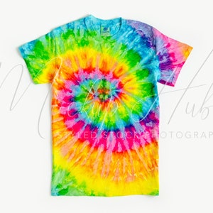 May include: A tie-dye t-shirt with a rainbow swirl pattern. The shirt is a light blue color with shades of pink, yellow, green, and orange.