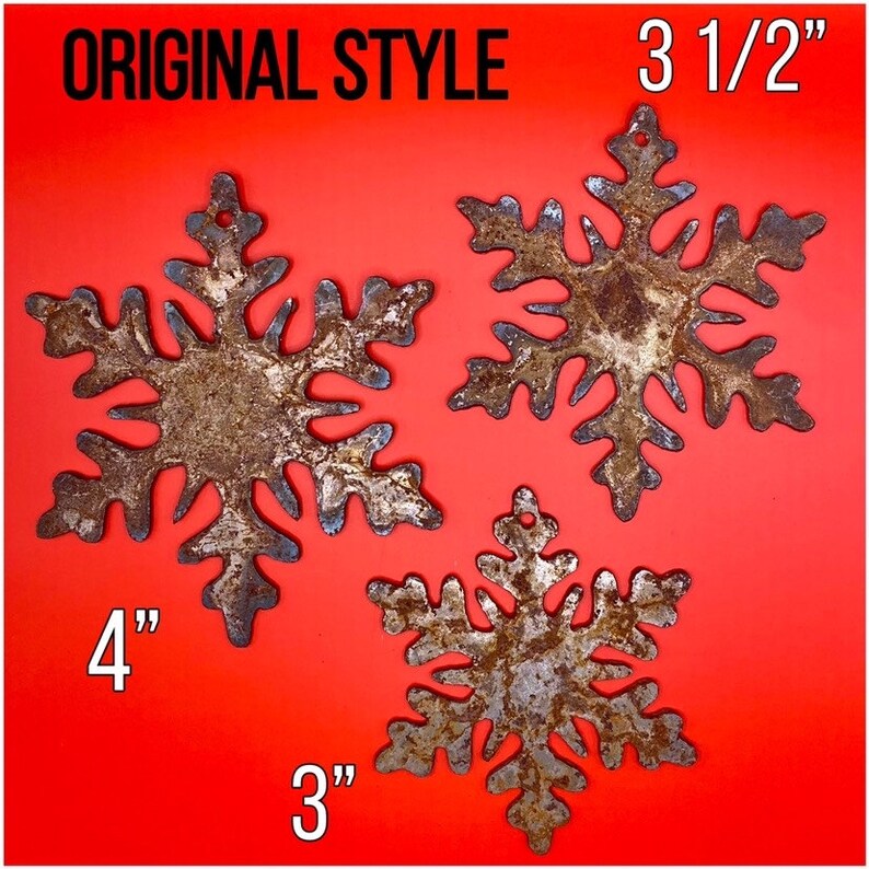May include: Three rustic metal snowflakes in varying sizes, with a distressed, aged appearance. The largest snowflake measures 4 inches, the medium one is 3.5 inches, and the smallest is 3 inches. The text "ORIGINAL STYLE" is at the top.