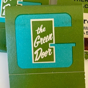 May include: Three vintage matchbooks with green and teal designs. Two matchbooks feature "the Green Door" in a white rectangle, while the third reads "GARDNER SLENDERIZING AND THERAPEUTIC MACHINES" and "Green Door" with a Texas address.