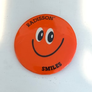 Vintage Radisson Smiles Button: Orange Smiley Face Pinback