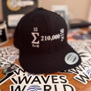 May include: Black baseball cap with a white embroidered mathematical equation:  "Σ_(i=0)^32 210,000^(50/2^i)".
