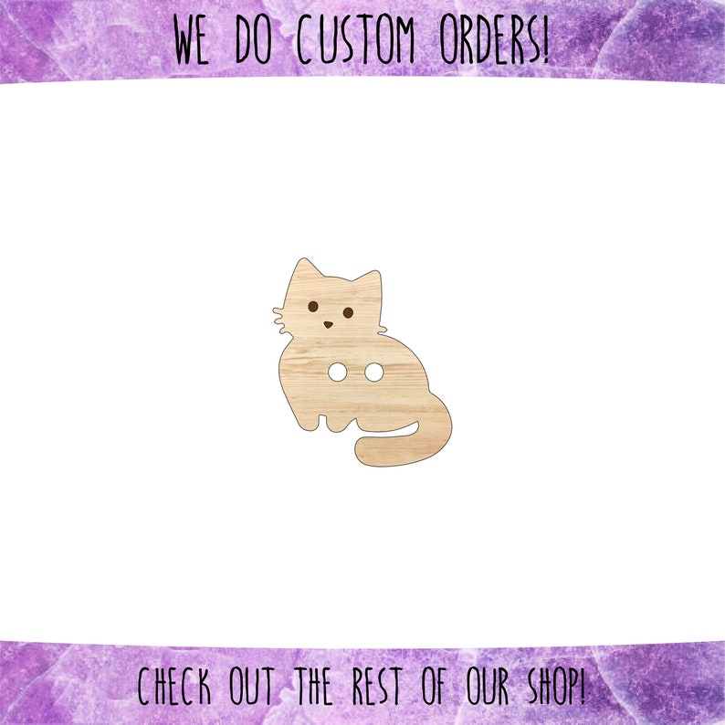 May include: A wooden cutout of a light brown cat with two holes for buttons. The cat is sitting with its tail curled around its legs. The text "WE DO CUSTOM ORDERS!" is at the top of the image and the text "CHECK OUT THE REST OF OUR SHOP!" is at the bottom of the image.