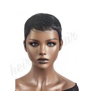 May include: A short black wig with a side part. The wig is styled in a pixie cut with a sleek finish.