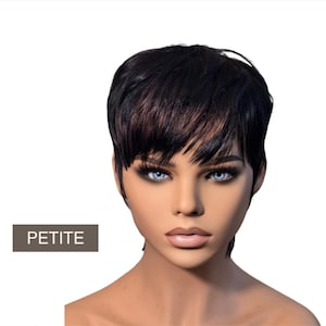 May include: A mannequin head with a short, black wig with auburn highlights. The wig has a layered, pixie cut style. The mannequin has blue eyes and full lips. The word "PETITE" is displayed on a rectangular label.