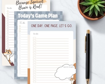 May include: Three notepads with to-do lists and squirrel illustrations. The top notepad reads "Because Squirrel Brain is Real!" The middle notepad says "Today's Game Plan." The bottom notepad says "One Day. One Page. Let's Go."