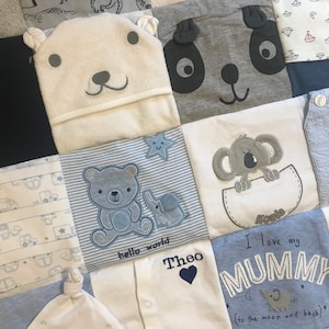 May include: A baby quilt made from squares of fabric, featuring appliqued animal faces like a polar bear, panda, and koala. Other squares show baby clothes with embroidered details, including a bear and elephant, and the text "hello world".