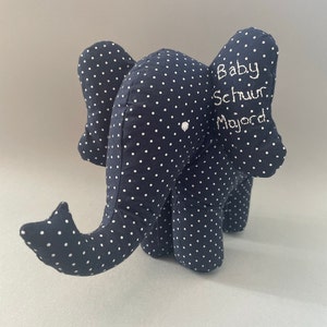 May include: A blue and white polka dot elephant stuffed animal with the text "Baby Schnur Major" embroidered on the side.