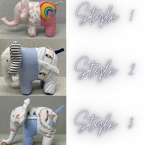 May include: Three handmade elephant plushies made from repurposed baby clothes. The first elephant is pink with a rainbow and the words "Just One" on the back. The second elephant is blue and white striped with a sailor design on the back. The third elephant is blue and white striped with a rainbow, sailboats, and a Peter Rabbit design on the back.