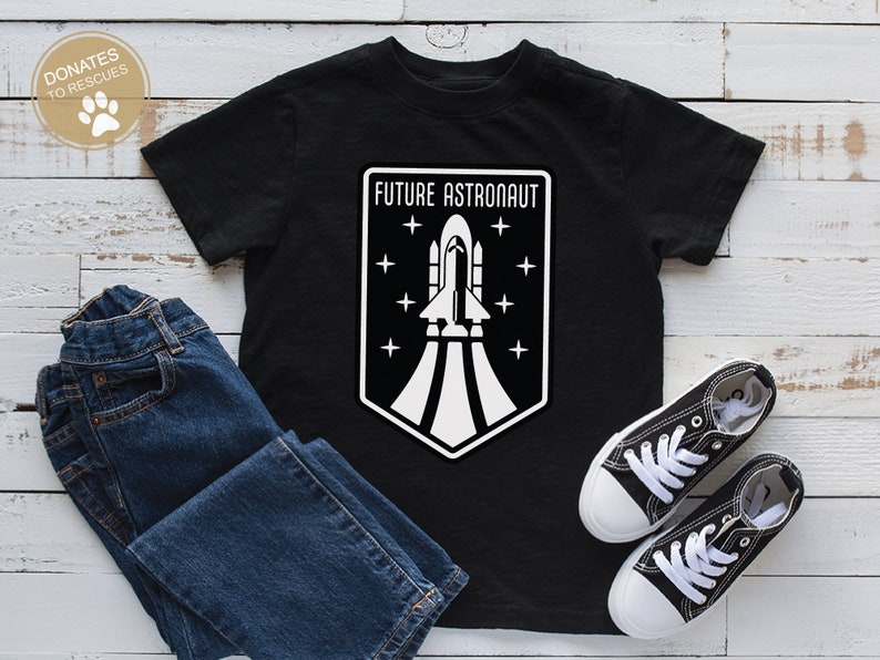 May include: Black t-shirt with a white graphic of a rocket ship and the text "FUTURE ASTRONAUT".