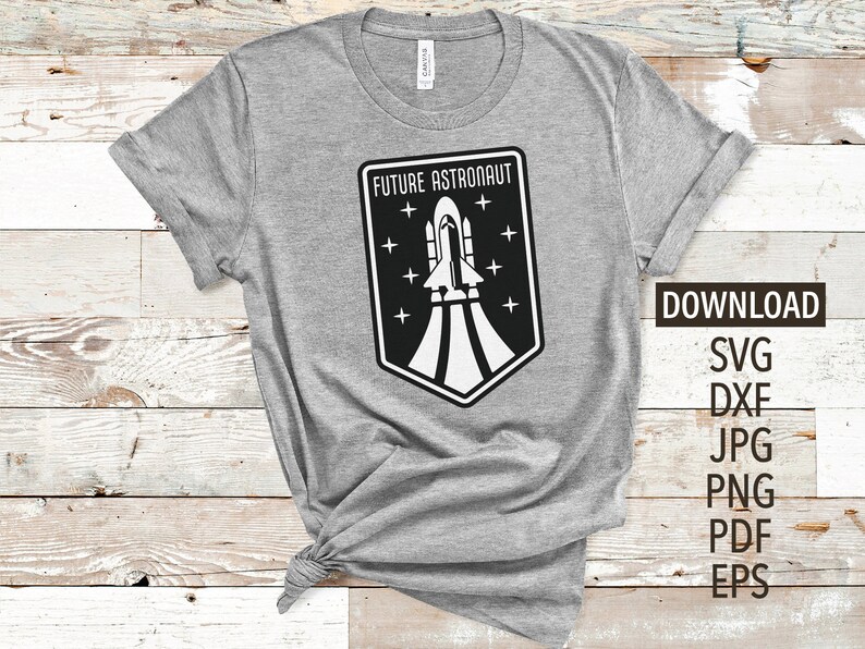 May include: A gray t-shirt with a black and white graphic of a rocket ship and the text "Future Astronaut".