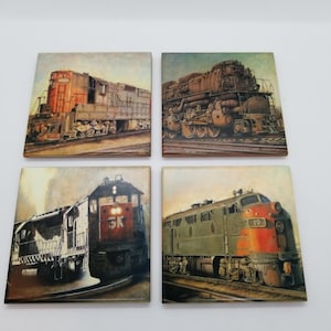 May include: Set of four ceramic coasters featuring vintage illustrations of trains. Each coaster depicts a different train with varying colors and designs. The coasters are square and have a rustic, vintage aesthetic.