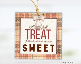 May include: A square gift tag with a plaid border in shades of orange and brown. The tag features the text "A little fall TREAT for someone extra SWEET" in a mix of fonts and colors. A small bow and twine are attached.