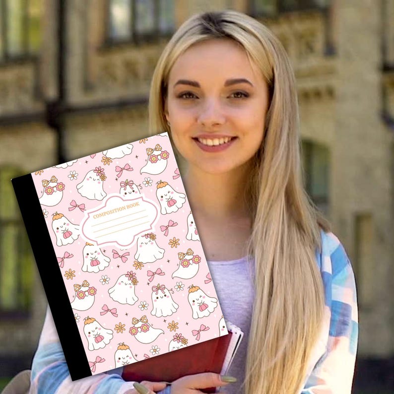 May include: A pink composition book featuring a pattern of adorable ghost characters adorned with bows and floral crowns. The cover includes the text "COMPOSITION BOOK" and a blank label. The book has a black spine.