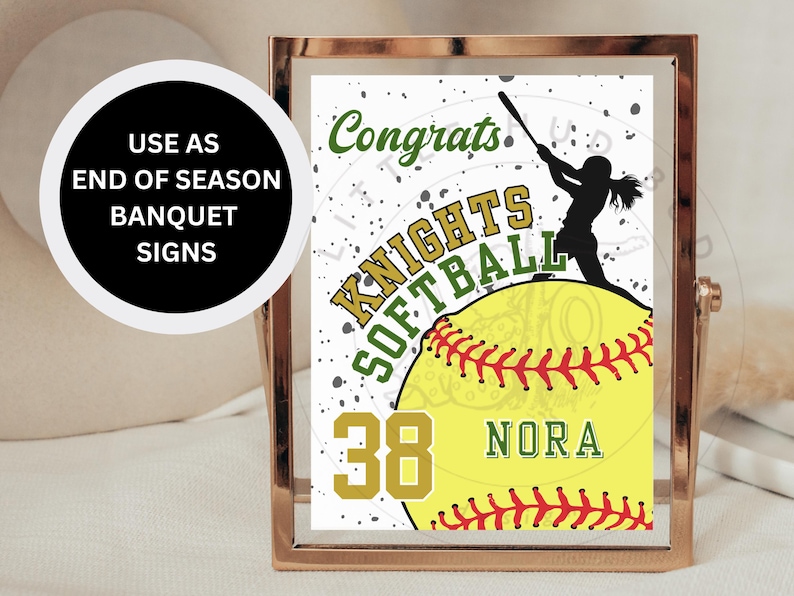 May include: A white and green sign with the text "Congrats Knights Softball" and a silhouette of a softball player. The sign also features a yellow softball with red stitching and the number 38 and the name "Nora" written on it.