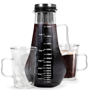 May include: A glass cold brew coffee maker with a stainless steel lid and a handle. The carafe has measurement markings in milliliters and cup increments. Two clear glass mugs are also in the image, one empty and one filled with coffee.